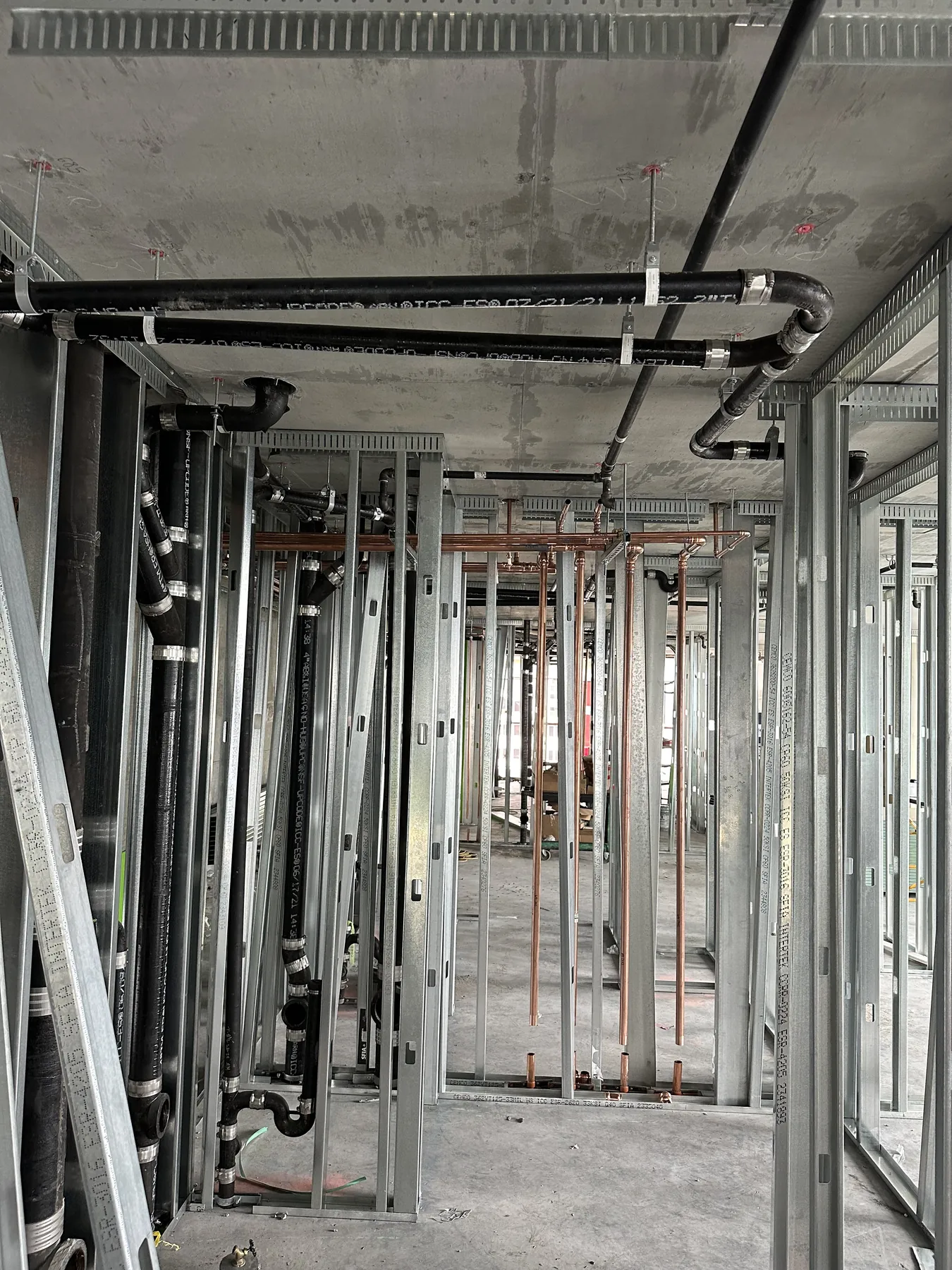 Poseidon Plumbing copper water line and drain rough-in inside a Southern California luxury residence under construction