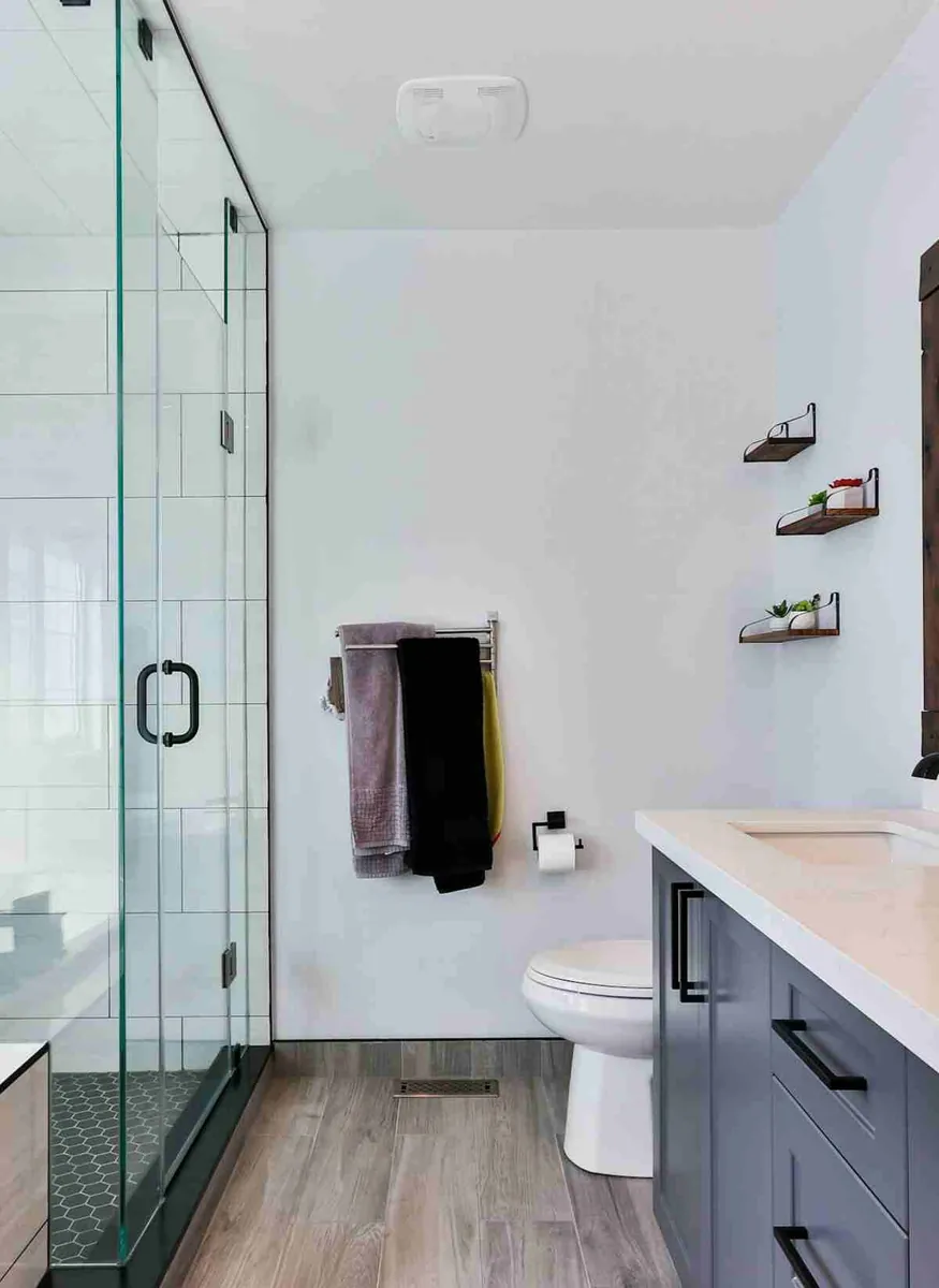 Custom home bathroom with frameless glass shower, wall-hung fixtures and floating vanity