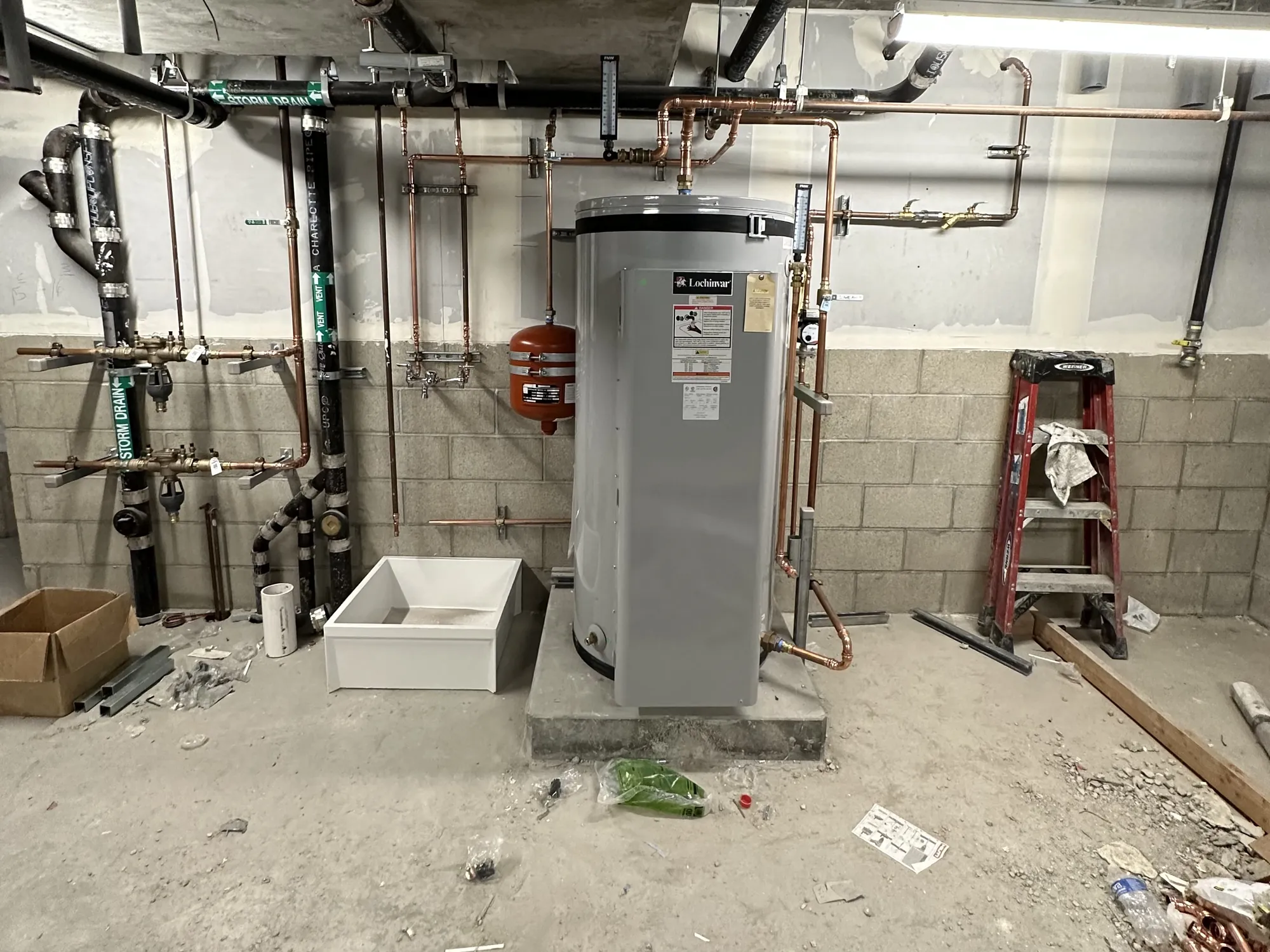 High-efficiency water heater with copper supply piping and expansion tank installed by Poseidon Plumbing