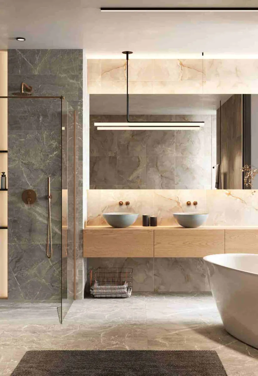 High-end remodel marble bathroom with brushed brass fixtures, vessel sinks and freestanding tub