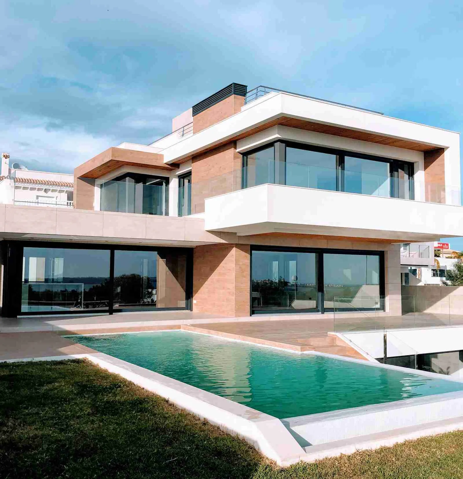 Modern luxury residence with pool terrace, representative of custom home plumbing projects in Southern California