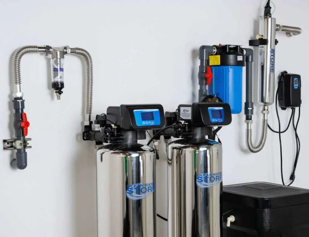 Whole home water filtration installation with dual softener tanks and UV purification